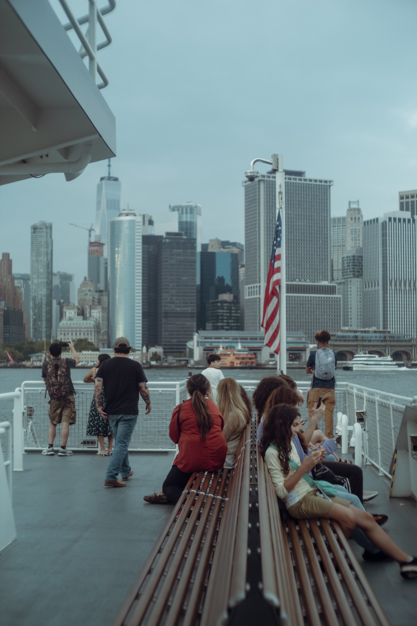 New York street photography downtown: ferry by Manhattan skyline