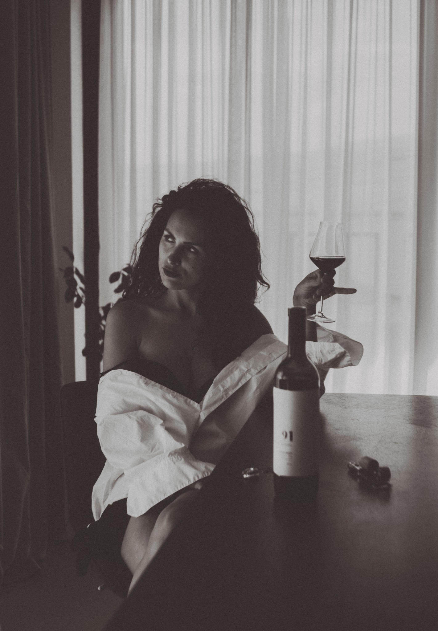 Quiet black and white portrait with a glass of wine