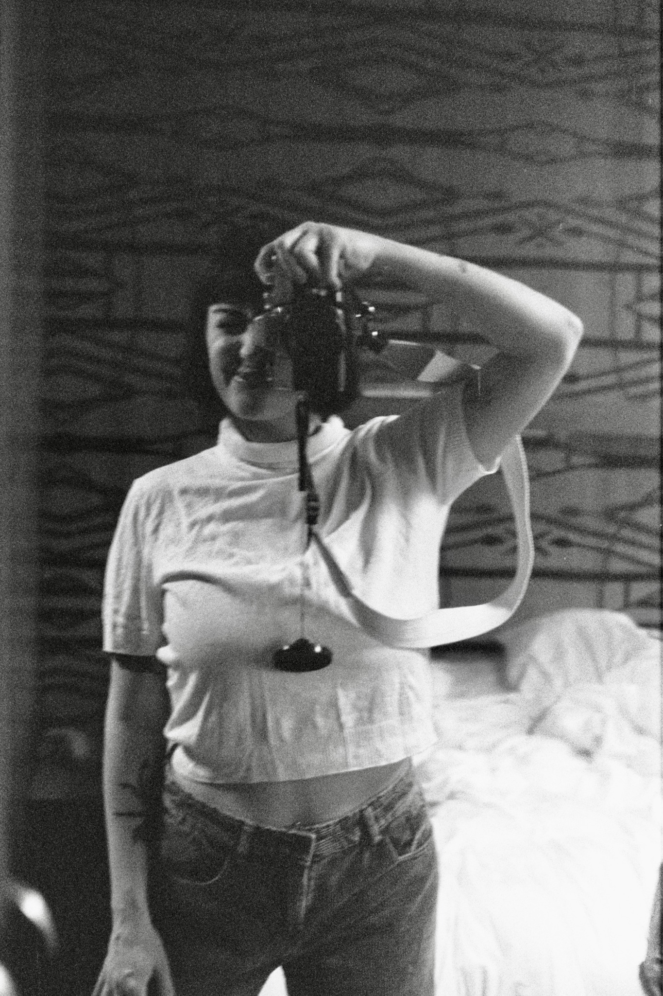 Lone Revz photographer holding a camera in a black-and-white mirror self portrait
